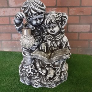 Boy and girl reading a book solar light
